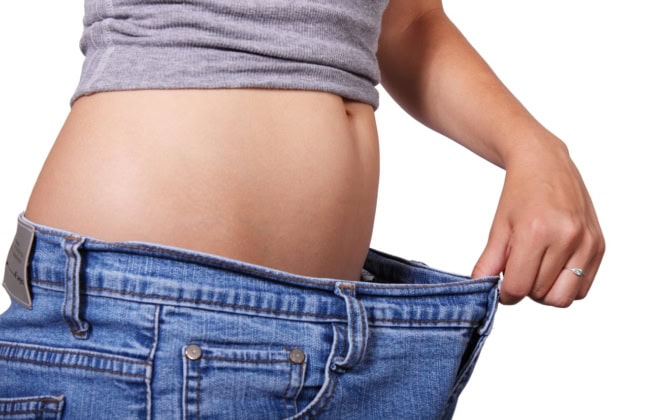 Woman showing weighloss belly How hypnotherapy helps weight loss