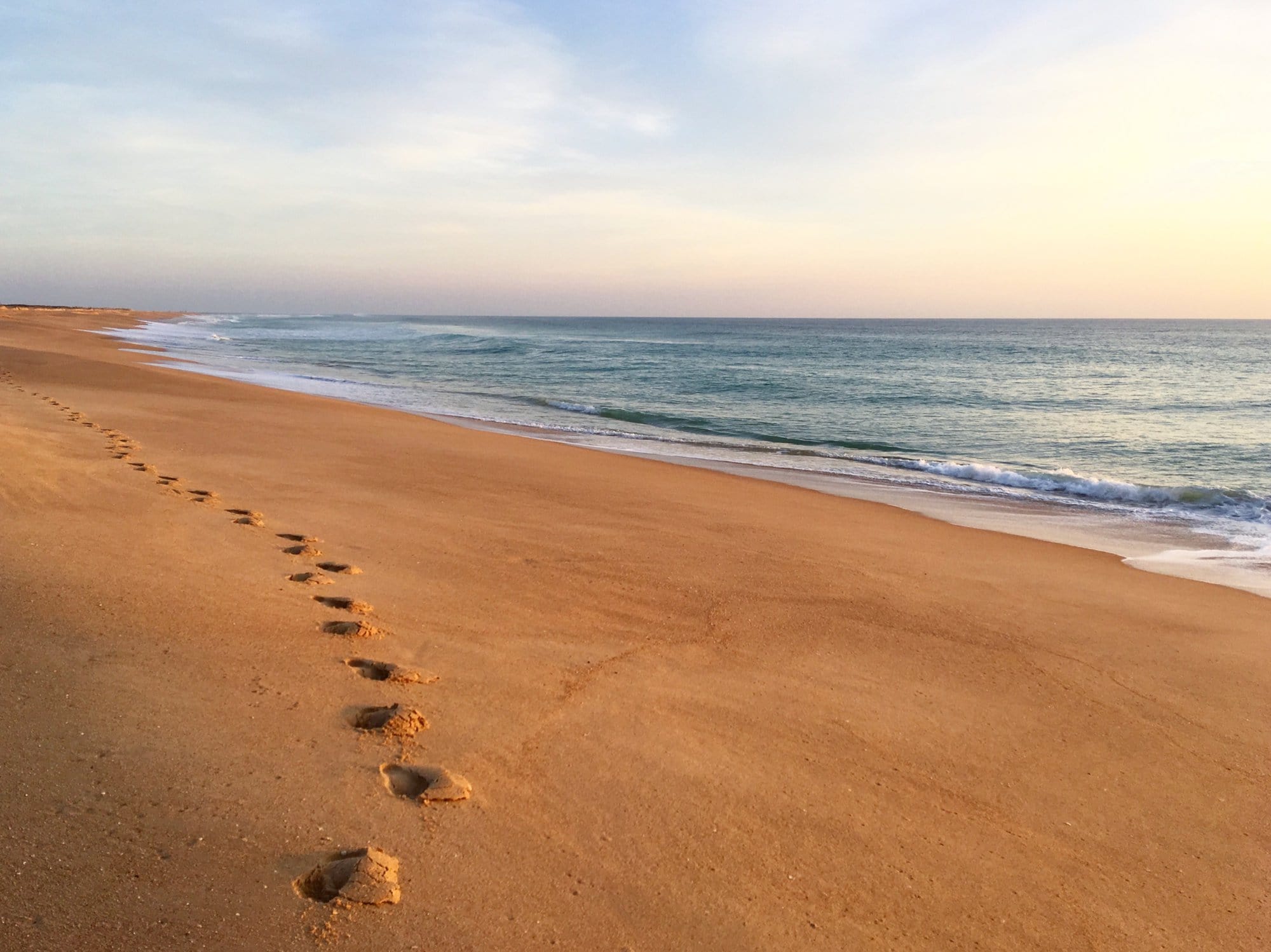Footsteps on a sandy beach