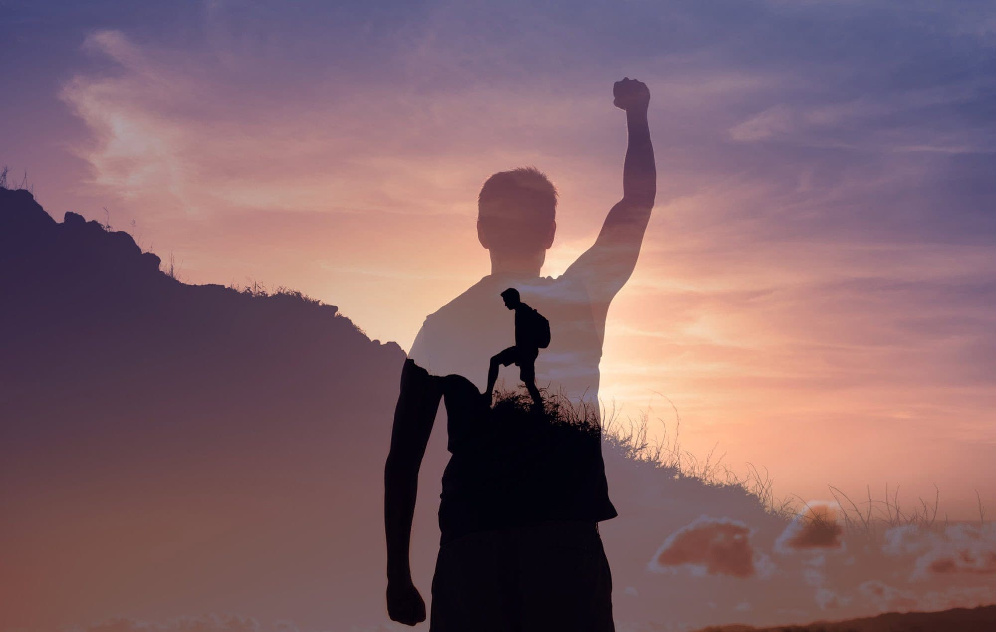 Man motivated to reach goals climbing mountain