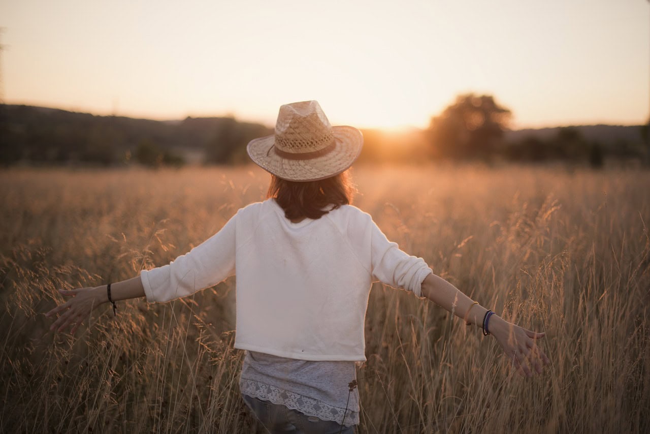 Woman in a field at sunset