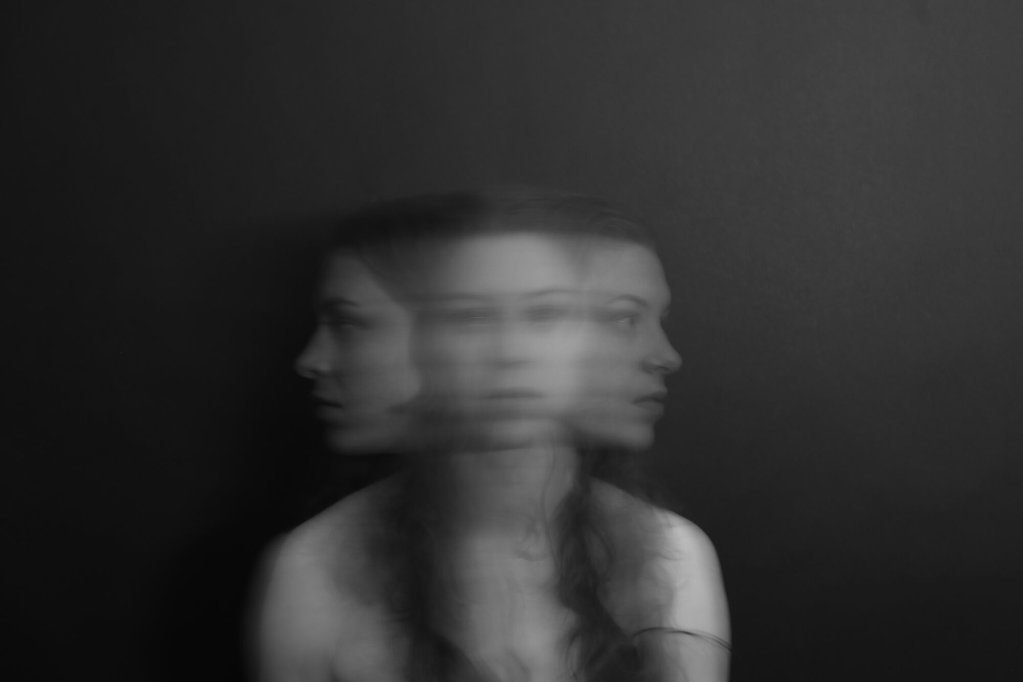 Blurred woman moving her head side to side representing anxiety disorders