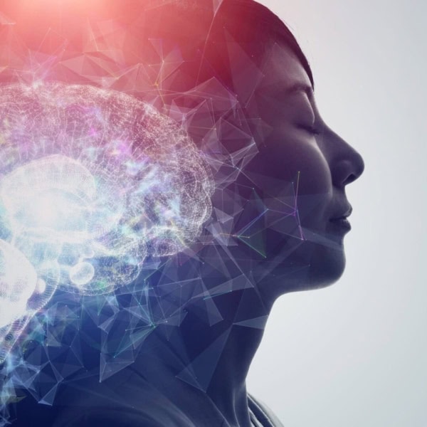 A woman's profile with a glowing brain symbolising NLP and hypnotherapy